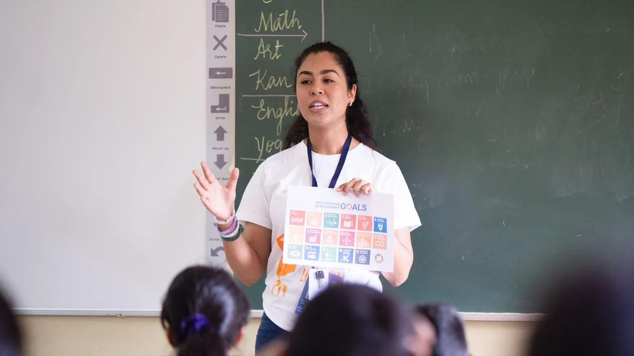 An AIESEC volunteer delivering an SDG education session in a Mongolian classroom