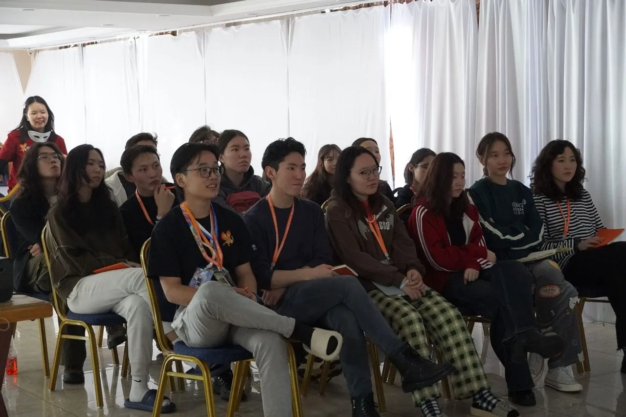 Mongolian delegates seated in a conference session listening to a speaker