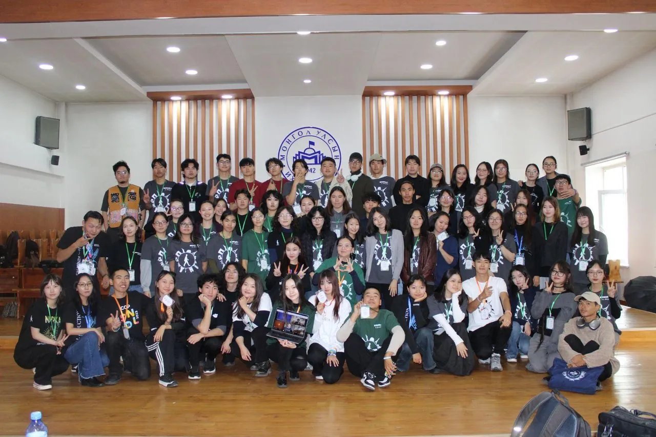 AIESEC Mongolia chapter members posing in front of a Mongolian university building